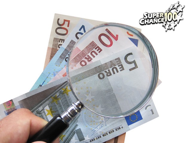 Une loupe sur des billets d'euros.